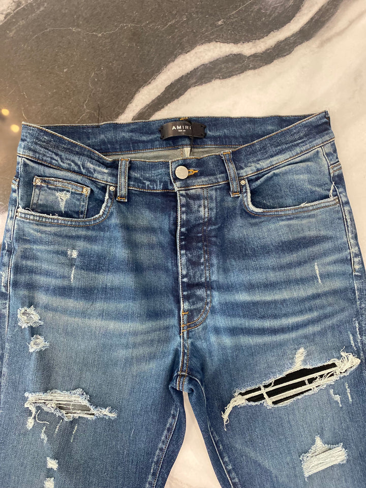 AMIRI MX1 DISTRESSED SKINNY LEG JEANS