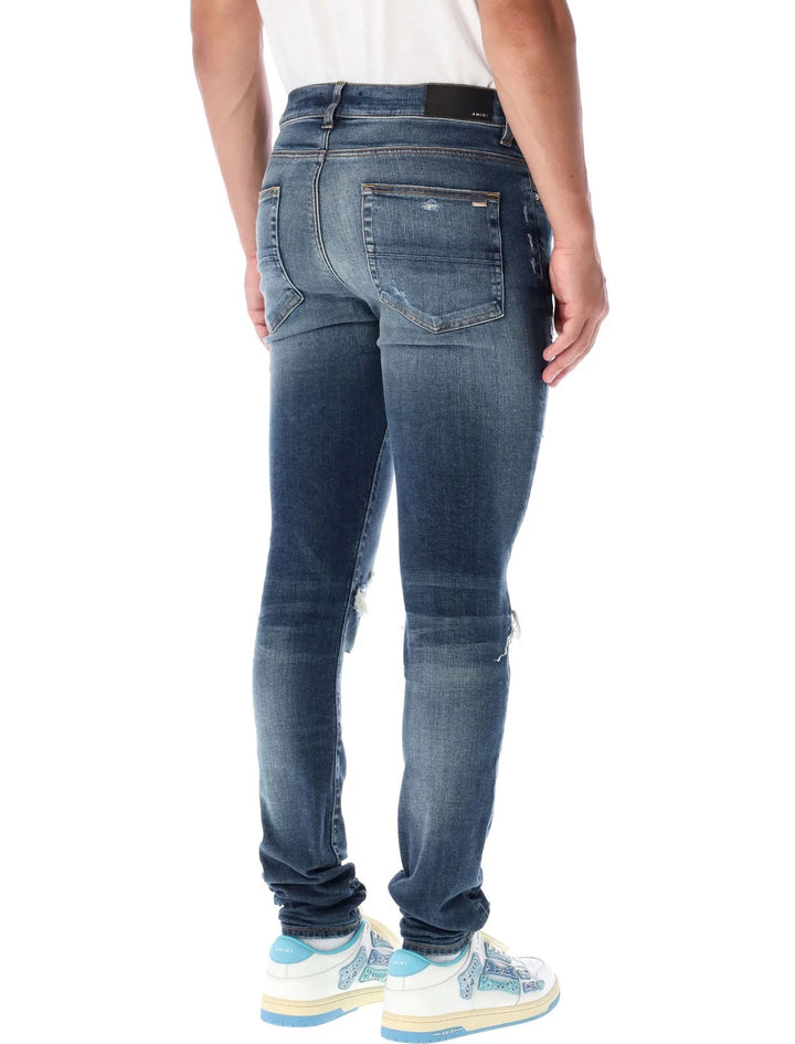 AMIRI MX1 DISTRESSED SKINNY LEG JEANS