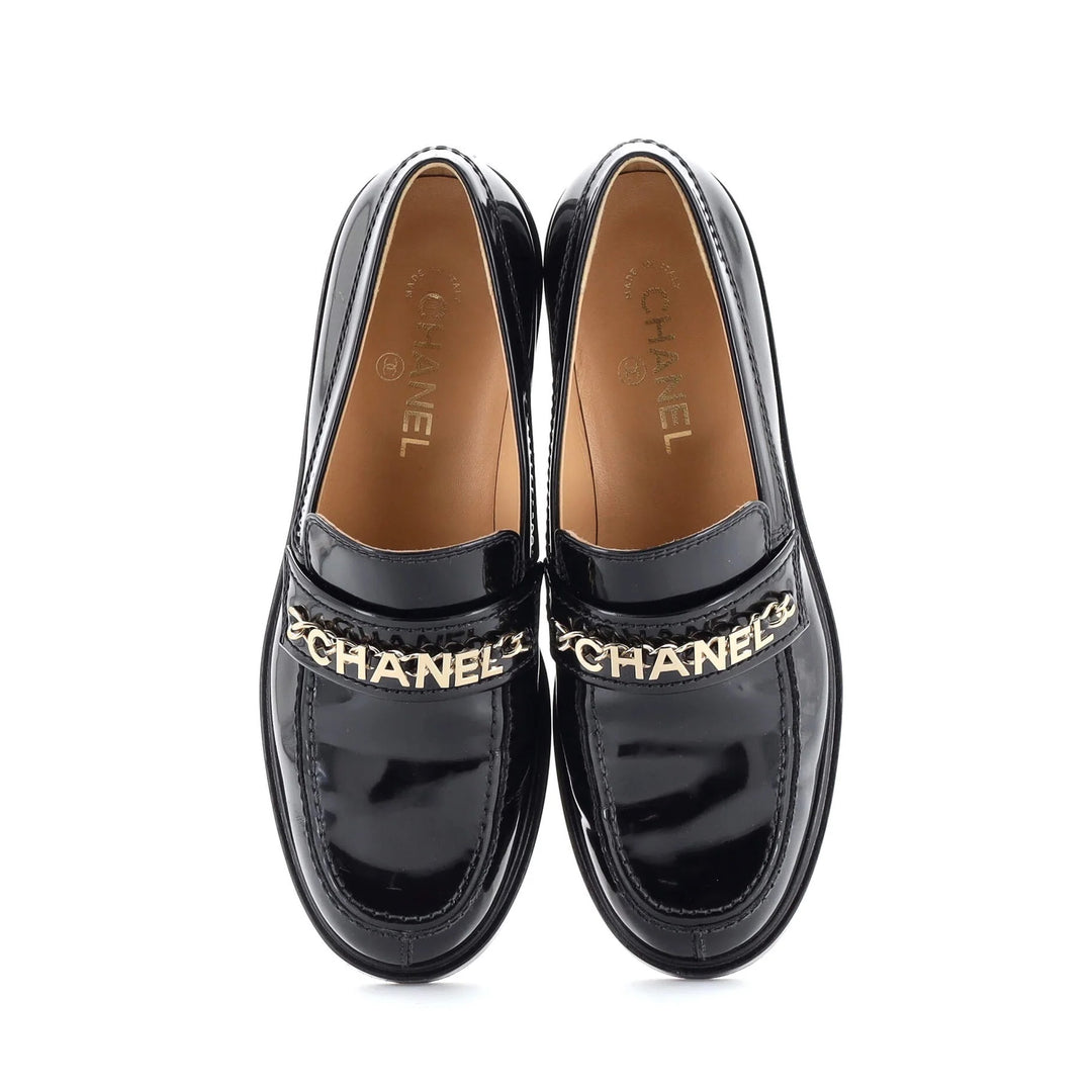 CHANEL SHINY PATENT CALFSKIN LOGO LOAFERS
