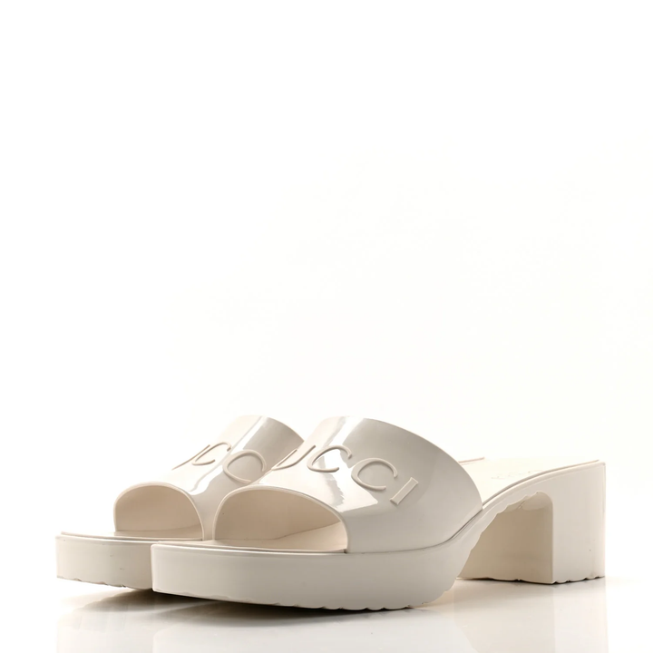 GUCCI EMBOSSED LOGO PLATFORM RUBBER MULES