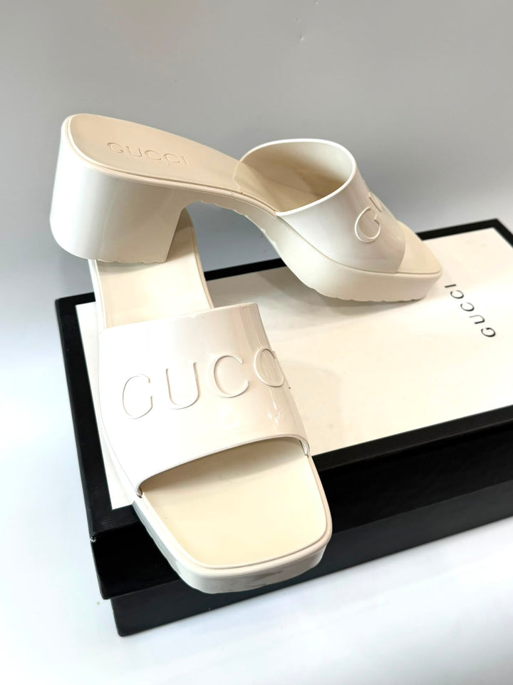 GUCCI EMBOSSED LOGO PLATFORM RUBBER MULES