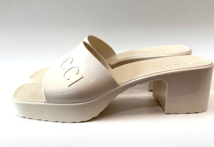 GUCCI EMBOSSED LOGO PLATFORM RUBBER MULES