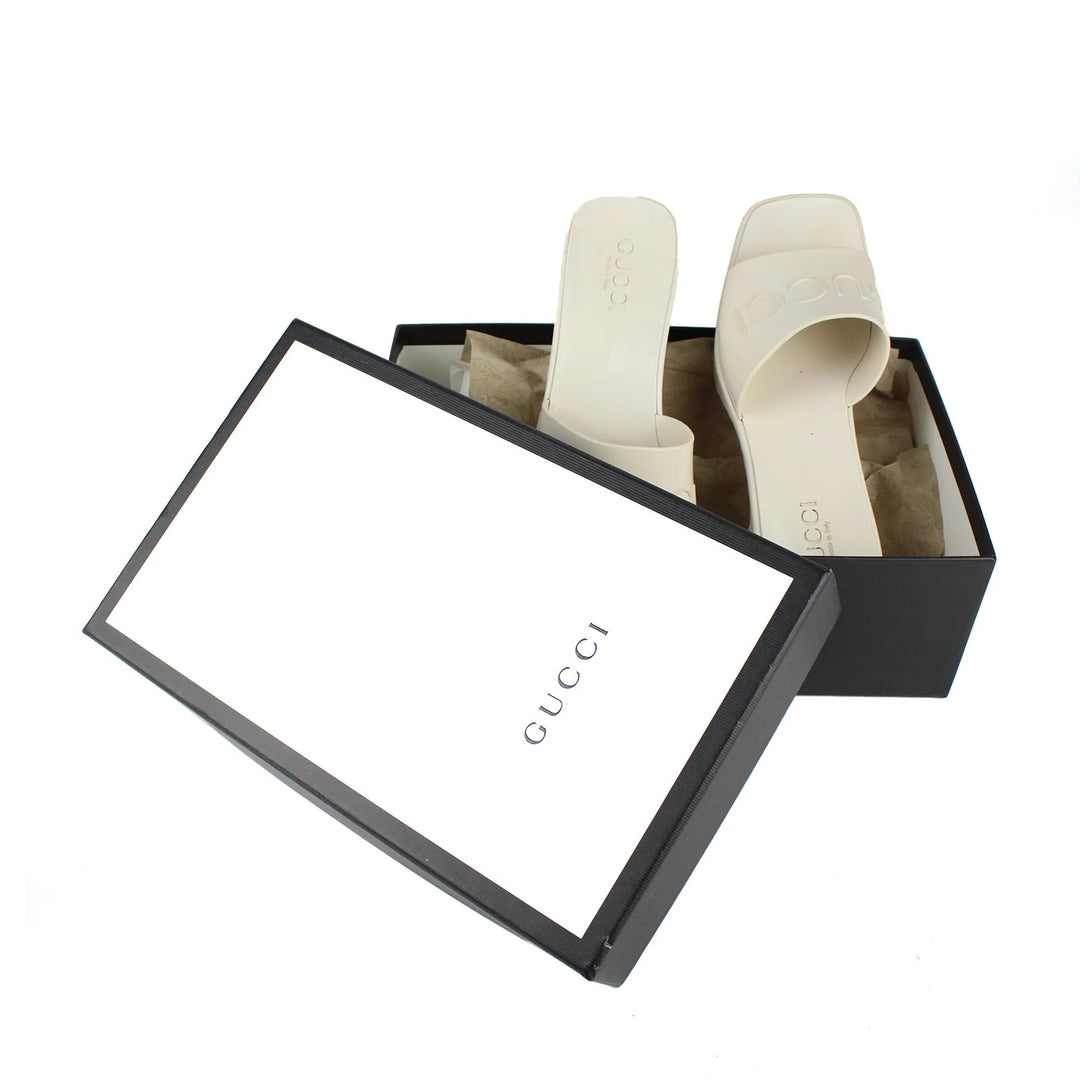 GUCCI EMBOSSED LOGO PLATFORM RUBBER MULES