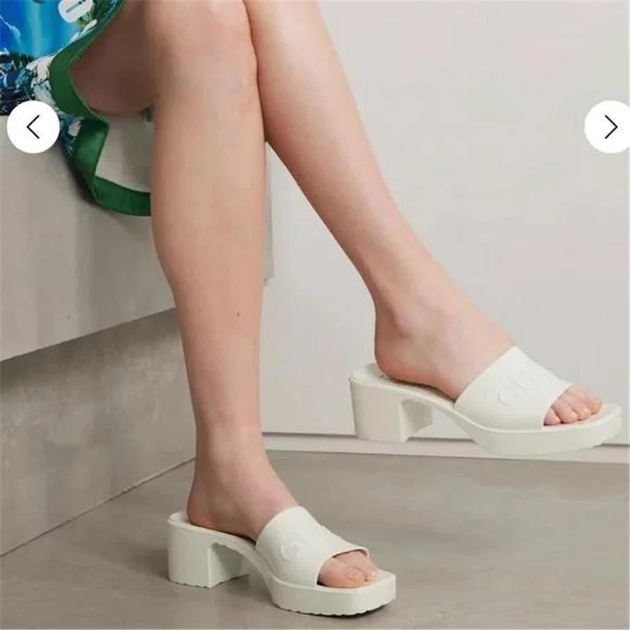 GUCCI EMBOSSED LOGO PLATFORM RUBBER MULES