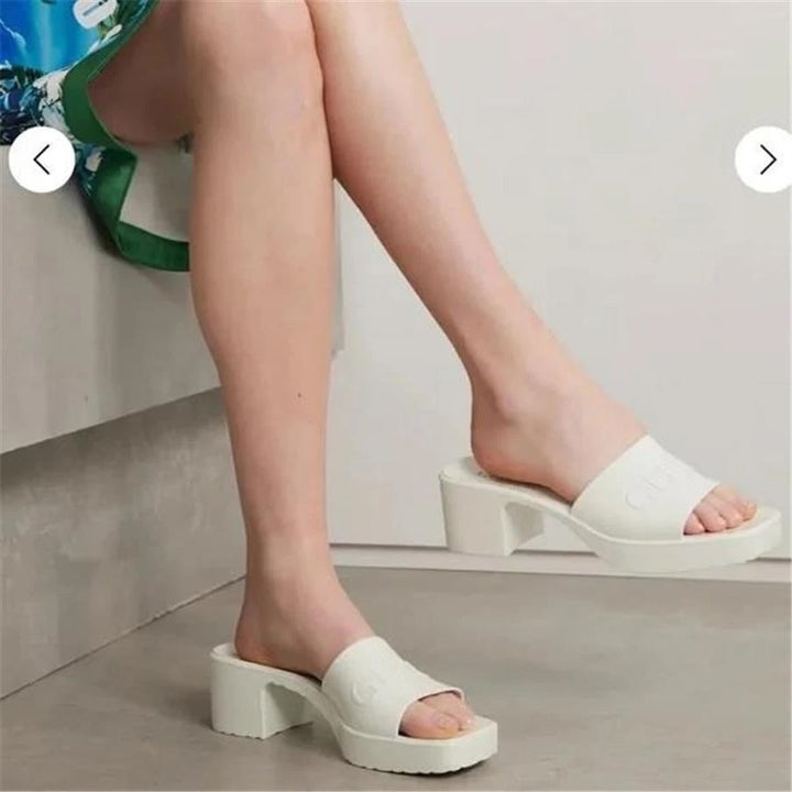 GUCCI EMBOSSED LOGO PLATFORM RUBBER MULES