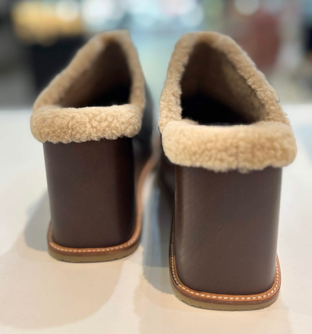 HERMÈS EARTH STUDDED SHEARLING WEDGE HEEL MULES