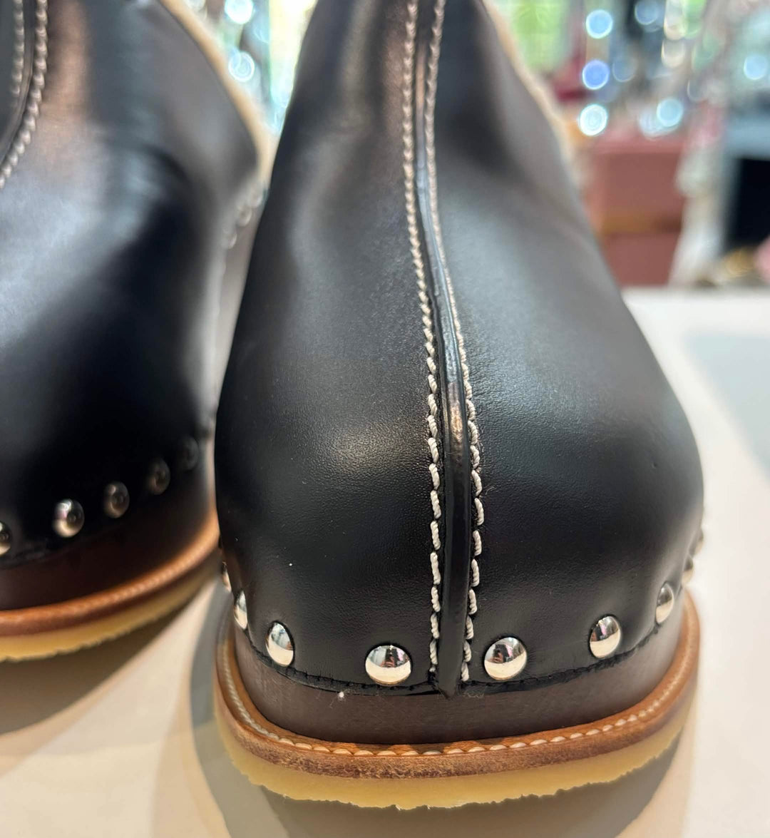 HERMÈS EARTH STUDDED SHEARLING WEDGE HEEL MULES